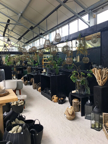 Eine belgische Grtnerei zeigt hier ein cooles modernes Design im Gewchshaus. Durch die reduzierte Farb- undProduktauswahl und die langen Strecken wird eine Reizberflutung vermieden.