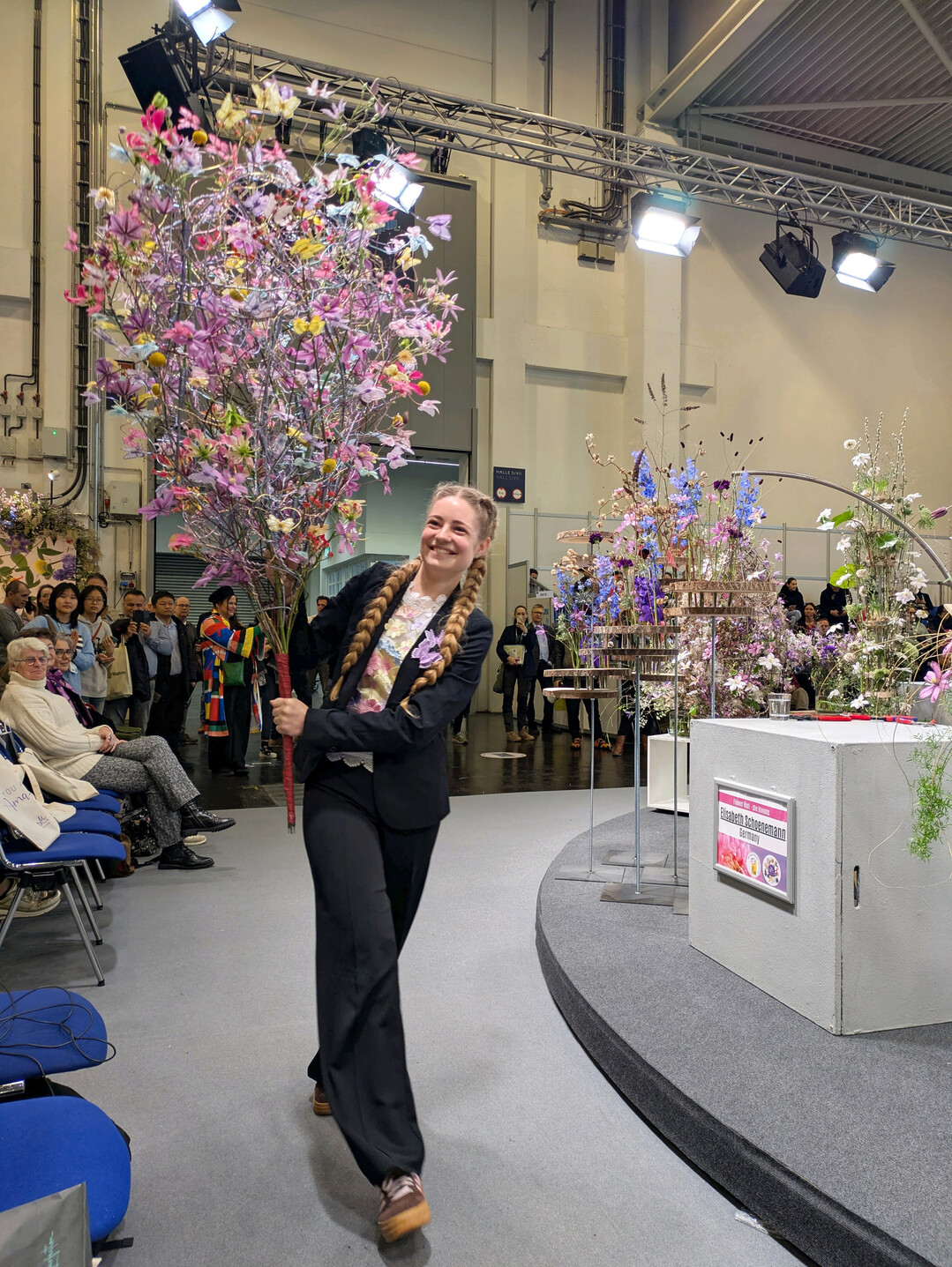 Carine Stel, Hanneke Frankema’s assistant, is carrying her oversized butterfly bouquet, which she created for Hanneke’s ‘Growth’ show at the World Cup of Floral Art in The Hague.