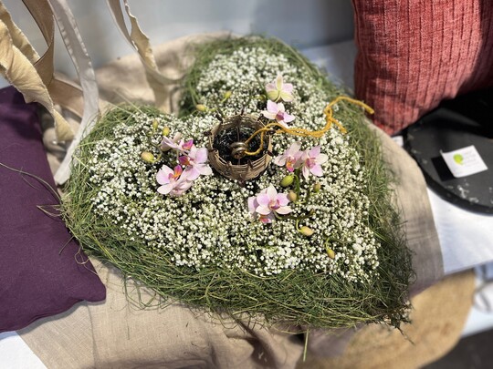 Herz (Oasis Unterlage) gesteckt mit Schleierkraut und Orchideen. Die Blten wurden eingebettet in getrocknete Grer. Um die Ringe angemessen in Szene zu setzen wurde mit Drhten und einer Textilschnur eine passendes Gef gewoben.