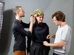 Oliver Ferchland und Tim Labenda schmücken das Modell mit der kunstvollen Chrysanthemen-Haube.